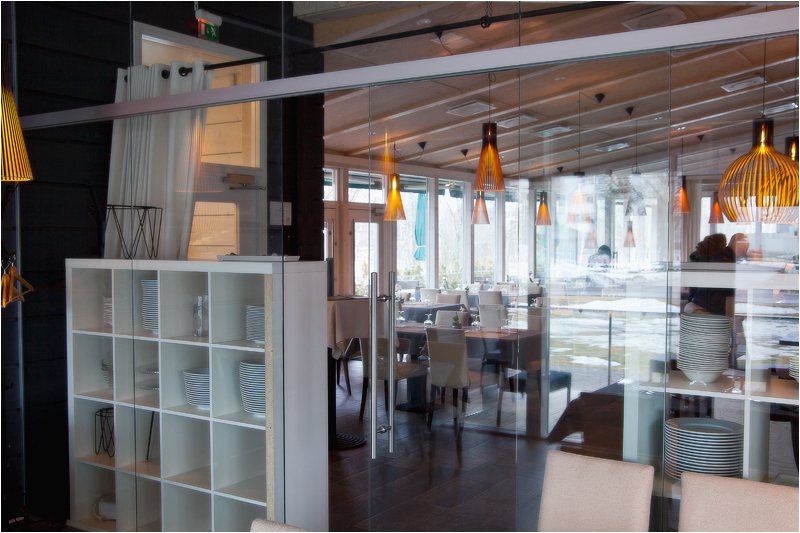 Ravintola Huili: lasinen jakoseinä ravintolasalissa